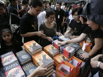 Harry Potter fans buy copies of J.K. Rowling's new book 'Harry Potter and the Deathly Hallows' in Bangkok July 21, 2007. The book is the seventh and final book in Rowling's series. REUTERS/Sukree Sukplang (THAILAND)
