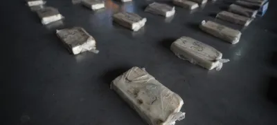Confiscated cocaine is shown to the press at a police hangar in Buenos Aires, Argentina, Thursday, Oct. 6, 2022. Police say they arrested three men from Peru and three from Paraguay with almost half a ton of pure cocaine brought by land from Peru that was going to be cut and distributed in Buenos Aires. (AP Photo/Victor R. Caivano)