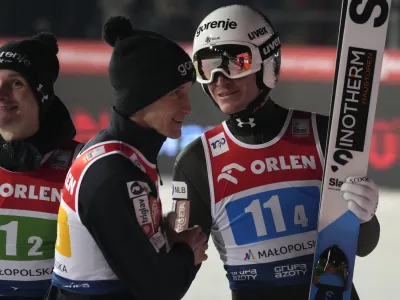 Slovenia's Anze Lanisek, right, smiles with teammates after the team competition of the Ski Jumping World Cup in Zakopane, Poland, Saturday, Jan. 20, 2024. (AP Photo/Czarek Sokolowski)