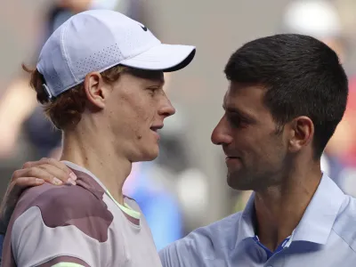 Jannik Sinner, left, of Italy is congratulated by Novak Djokovic of Serbia following their semifinal at the Australian Open tennis championships at Melbourne Park, Melbourne, Australia, Friday, Jan. 26, 2024. (AP Photo/Asanka Brendon Ratnayake)