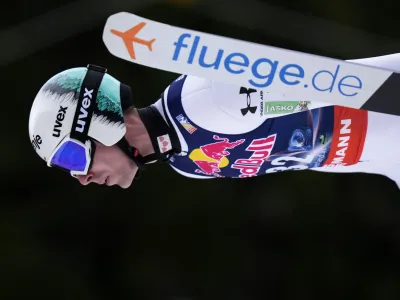 Timi Zajc, of Slovenia, soars through the air during his first round jump of the ski flying world championships, at the Kulmkogel mountain in Bad Mitterndorf, Austria, Friday, Jan. 26, 2024. (AP Photo/Matthias Schrader)