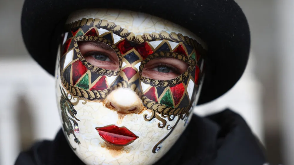 A masked reveller takes part in the Venice carnival in St. Mark's Square in Venice, Italy, January 27, 2024. REUTERS/Guglielmo Mangiapane