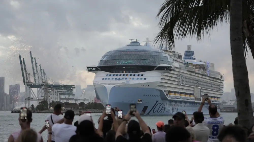 People film from South Pointe Park, as Icon of the Seas, the world's largest cruise ship, sails out of PortMiami on its first public cruise, in Miami Beach, Fla., Saturday, Jan. 27, 2024. (AP Photo/Rebecca Blackwell)