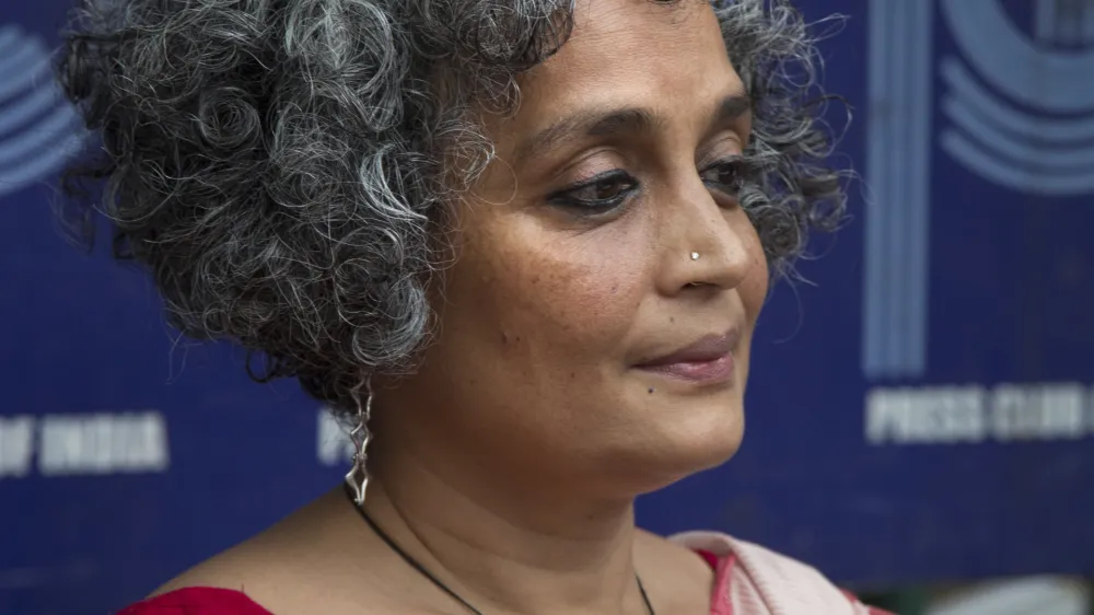 Writer activist Arundhati Roy sits for a press conference opposing the arrests this week of five prominent rights activists, in New Delhi, India, Thursday, Aug. 30, 2018. (AP Photo/Manish Swarup)