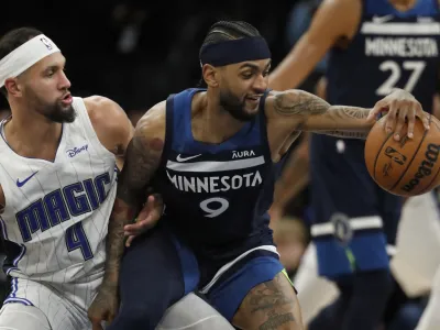 Feb 2, 2024; Minneapolis, Minnesota, USA; Minnesota Timberwolves guard Nickeil Alexander-Walker (9) works around Orlando Magic guard Jalen Suggs (4) in the fourth quarter at Target Center. Mandatory Credit: Bruce Kluckhohn-USA TODAY Sports