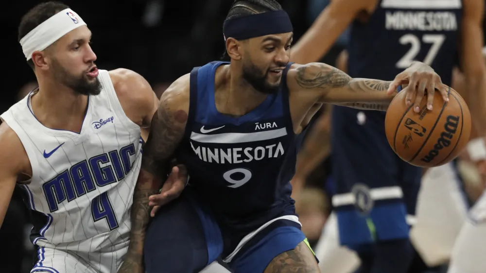 Feb 2, 2024; Minneapolis, Minnesota, USA; Minnesota Timberwolves guard Nickeil Alexander-Walker (9) works around Orlando Magic guard Jalen Suggs (4) in the fourth quarter at Target Center. Mandatory Credit: Bruce Kluckhohn-USA TODAY Sports
