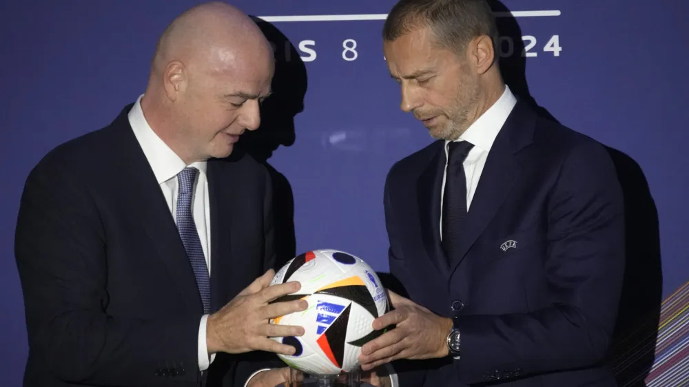 UEFA President Aleksander Ceferin, right, and FIFA President Gianni Infantino pose during the 48th UEFA congress in Paris, Thursday, Feb. 8, 2024. (AP Photo/Christophe Ena)