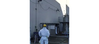 In this photo provided by Tokyo Electric Power Company Holdings, Inc. (TEPCO), a staff member examines an air vent through which a plant worker found the leak Wednesday morning, at the crippled Fukushima Daiichi nuclear power plant in Okuma town, northeastern Japan, Wednesday, Feb. 7, 2024. Highly radioactive water leaked from a treatment machine at the tsunami-hit Fukushima nuclear power plant, but no one was injured and radiation monitoring shows no impact to the outside environment, the utility operator said Thursday. (TEPCO via AP)
