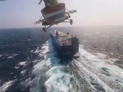 FILE PHOTO: Houthi military helicopter flies over the Galaxy Leader cargo ship in the Red Sea in this photo released November 20, 2023. Houthi Military Media/Handout via REUTERS/File Photo