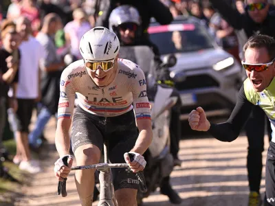 Slovenia's Tadej Pogacar competes during the men's Strade Bianche' (White Roads) cycling race from and to Siena, Italy, Saturday, March 2, 2024. (Fabio Ferrari/LaPresse via AP)