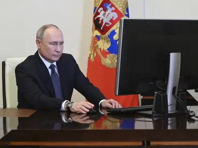 Russian President Vladimir Putin attends an electronic voting during a presidential voting at the Novo-Ogaryovo state residence outside Moscow, Russia, Friday, March 15, 2024. (Pavel Byrkin, Sputnik, Kremlin Pool Photo via AP)