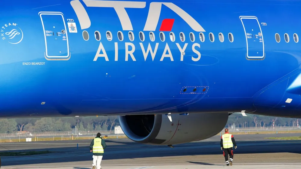 FILE PHOTO: An Italian carrier Italia Trasporto Aereo (ITA Airways) plane is checked by workers at Fiumicino airport in Rome, Italy, January 31, 2023. REUTERS/Remo Casilli/File Photo