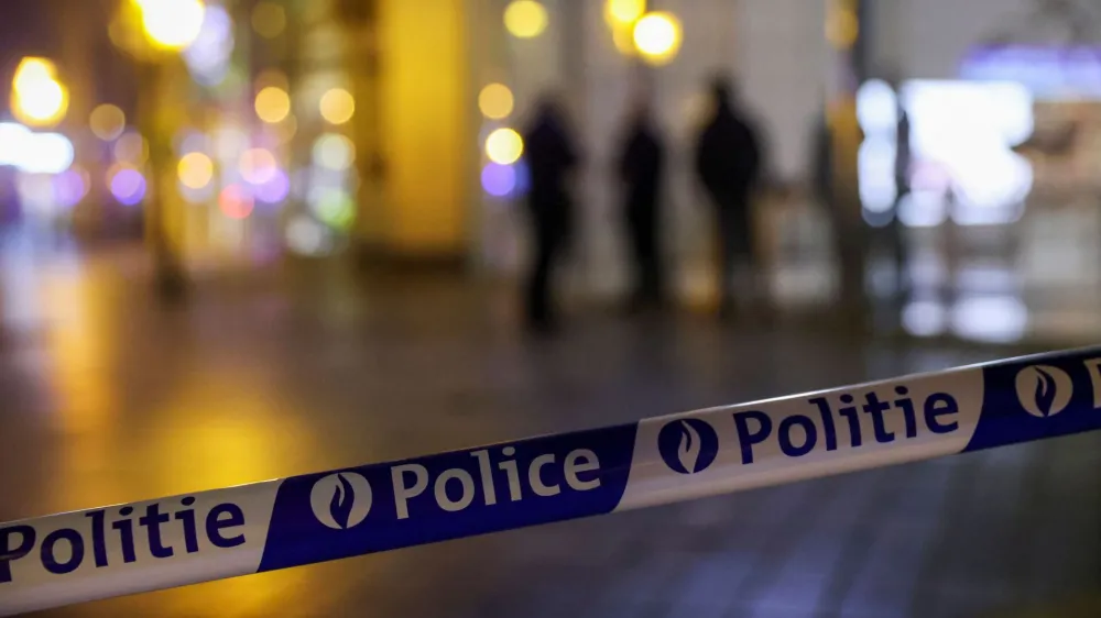 Police barricade tape is seen, as Belgian police keep guard outside the area where, according to police, a shooting took place, injuring several police officers, in Brussels, Belgium, December 6, 2023. REUTERS/Johanna Geron