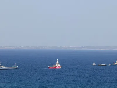 The Open Arms, a rescue vessel owned by a Spanish NGO, a cargo ship and a tug boat depart with humanitarian aid for Gaza from Larnaca, Cyprus, March 30, 2024. REUTERS/Yiannis Kourtoglou