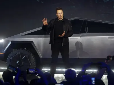 Tesla CEO Elon Musk introduces the Cybertruck at Tesla's design studio Thursday, Nov. 21, 2019, in Hawthorne, Calif. Musk is taking on the workhorse heavy pickup truck market with his latest electric vehicle. (AP Photo/Ringo H.W. Chiu)
