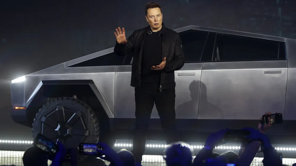 Tesla CEO Elon Musk introduces the Cybertruck at Tesla's design studio Thursday, Nov. 21, 2019, in Hawthorne, Calif. Musk is taking on the workhorse heavy pickup truck market with his latest electric vehicle. (AP Photo/Ringo H.W. Chiu)