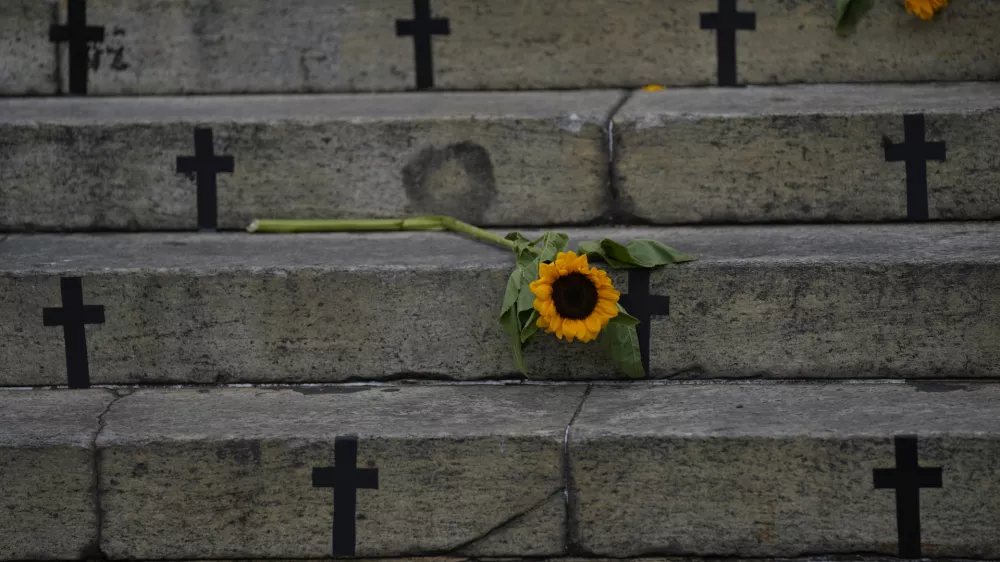 Sunflowers and crosses cover the City Council steps during a protest against femicide on International Women's Day in Rio de Janeiro, Brazil, Friday, March 8, 2024. (AP Photo/Silvia Izquierdo)
