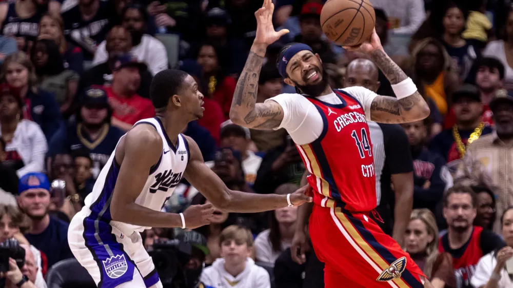 Apr 19, 2024; New Orleans, Louisiana, USA; New Orleans Pelicans forward Brandon Ingram (14) dribbles against Sacramento Kings guard De'Aaron Fox (5) in the second half during a play-in game of the 2024 NBA playoffs at Smoothie King Center. Mandatory Credit: Stephen Lew-USA TODAY Sports