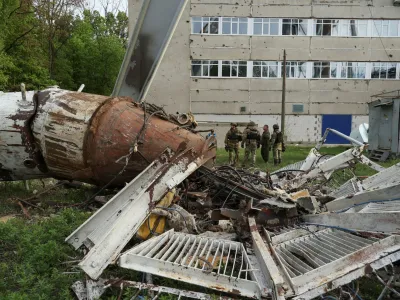 Police officers stand next to a part of a television tower partially destroyed by a Russian missile strike, amid Russia's attack on Ukraine, in Kharkiv, Ukraine April 22, 2024. REUTERS/Sofiia Gatilova