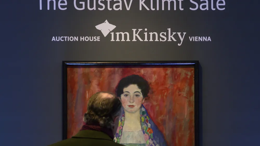 A man looks at the painting 'Portrait of Fr&auml;ulein Lieser' by Austrian painter Gustav Klimt prior to an auction, in Vienna, Wednesday, April 24, 2024. A portrait of a young woman by Gustav Klimt that was long believed to be lost has been sold at an auction in Vienna for 30 million euros ($32 million). The Austrian modernist artist started work on the "Portrait of Fr&auml;ulein Lieser" in 1917, the year before he died, and it is one of his last works. (AP Photo/Christian Bruna)