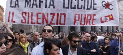 People gather during a demonstration of solidarity in front of Rome's Pantheon for the victims of the explosive device that went off near the "Francesca Morvillo Falcone" high school in Brindisi, Italy, Saturday, May 19, 2012. An explosive device went off outside a high school in southern Italy named after a slain anti-Mafia prosecutor as students arrived for class Saturday, killing one of them and wounding seven others, officials said. The device went off just before 8 a.m. in the Adriatic port town of Brindisi just as students milled outside, chatting and getting ready for class at the vocational institute named after the slain anti-Mafia prosecutor Giovanni Falcone and his wife. The banner reads: "Mafia kills, silence as well (kills)". (AP Photo/Roberto Monaldo, Lapresse) ITALY OUT