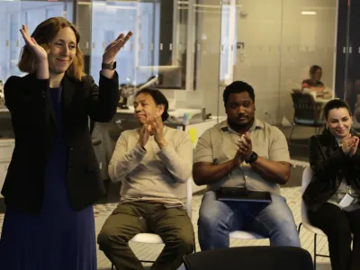Executive Editor Julie Pace, left, reacts on Monday, May 6, 2024, in New York after it was announced that the Associated Press won the Pulitzer Prize for Feature Photography. Along with honoring winners and finalists in 15 journalism categories, the Pulitzer Board also recognizes distinguished work in areas including books, music and theater. (AP Photo/Peter Morgan)