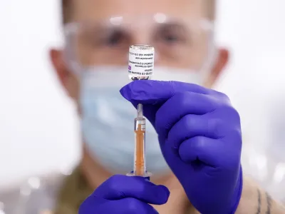 08 February 2021, England, Leeds: Sgt Phil Morris, Regimental Aid Post 4th Battalion Royal Regiment of Scotland, prepares a dose of the Oxford/AstraZeneca coronavirus vaccine ahead of being administered to patients at the Elland Road vaccination centre. Photo: Danny Lawson/PA Wire/dpa