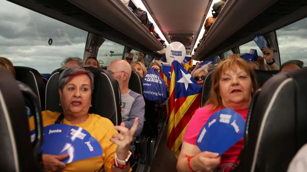 Supporters of exiled Catalan separatist leader Carles Puigdemont hold Esteladas (Catalan separatist flag) as they sing inside a bus, during their travel to France for a Junts Per Catalunya (Together for Catalonia) party rally, in La Jonquera near France, in Spain, May 7, 2024. REUTERS/Nacho Doce