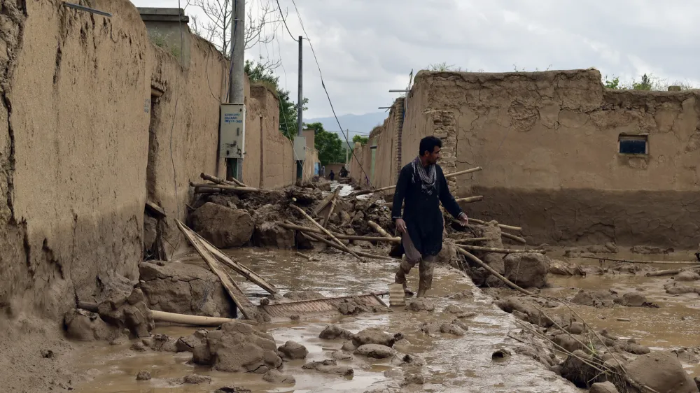 An Afghan man walks near his damaged home after heavy flooding in Baghlan province in northern Afghanistan Saturday, May 11, 2024. Flash floods from seasonal rains in Baghlan province in northern Afghanistan killed dozens of people on Friday, a Taliban official said. (AP Photo/Mehrab Ibrahimi)
