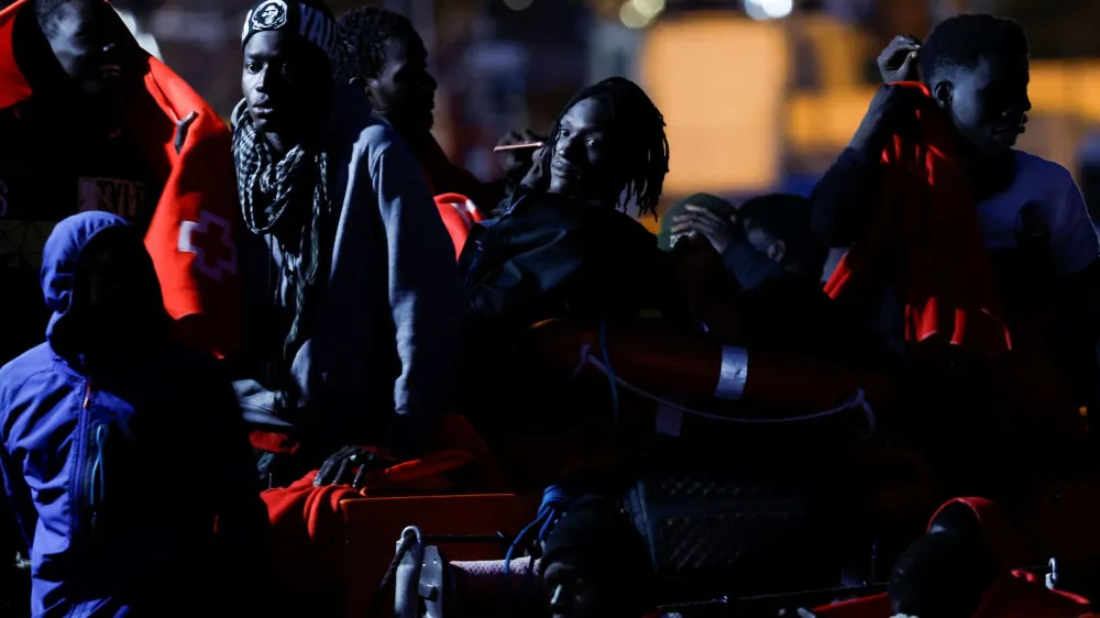 Migrants wait to disembark from a Spanish coast guard vessel, in the port of Arguineguin, on the island of Gran Canaria, Spain, May 13, 2024. REUTERS/Borja Suarez