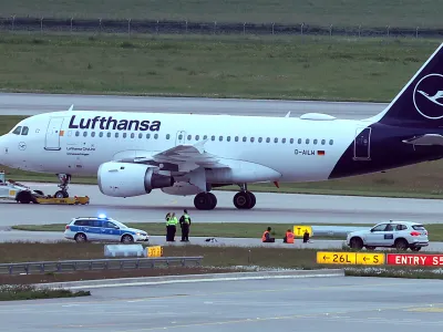 18 May 2024, Bavaria, Munich: Two activists have glued themselves to an access road for runways at Franz-Josef-Strau&szlig; Airport. The activists had reached the inner area of the airport grounds. According to their own statements, members of the 'Last Generation' activism group had planned to enter the airport grounds in order to block at least one of the two runways. Photo: Karl-Josef Hildenbrand/dpa