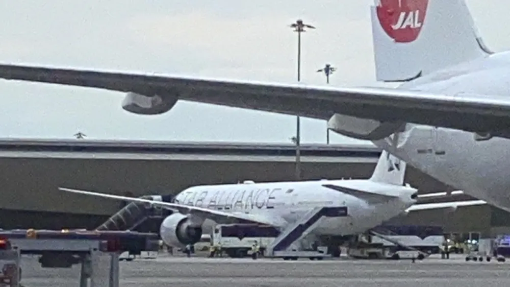 The Boeing 777-300ER aircraft of Singapore Airlines, flight SQ321 from Heathrow is seen on tarmac after requesting an emergency landing at Bangkok's Suvarnabhumi International airport, Thailand, Tuesday, May 21, 2024. One person has died aboard a London-Singapore flight that encountered severe turbulence, Singapore Airlines said Tuesday, in which the plane apparently plummeted for a number of minutes before it was diverted to Bangkok, where emergency crews rushed to help injured passengers amid stormy weather. (Pongsakorn Rodphai via AP)
