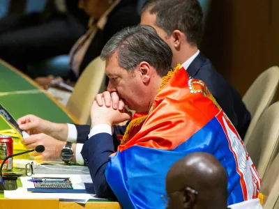 Serbian President Aleksandar Vucic wears a Serbian flag as he listens to delegates after the United Nations General Assembly's vote on the creation of an international day to commemorate the Srebrenica genocide, at the United Nations Headquarters in New York City, U.S. May 23, 2024. REUTERS/Eduardo Munoz