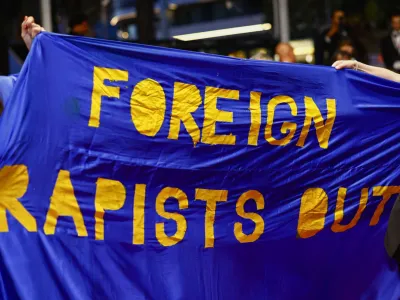 People hold a banner on the red carpet during arrivals for the screening of the film "All We Imagine as Light" in competition at the 77th Cannes Film Festival in Cannes, France, May 23, 2024. REUTERS/Sarah Meyssonnier