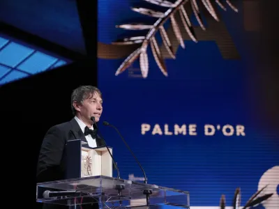 Sean Baker accepts the Palme d'Or for the film 'Anora,' during the awards ceremony of the 77th international film festival, Cannes, southern France, Saturday, May 25, 2024 (Photo by Andreea Alexandru/Invision/AP)