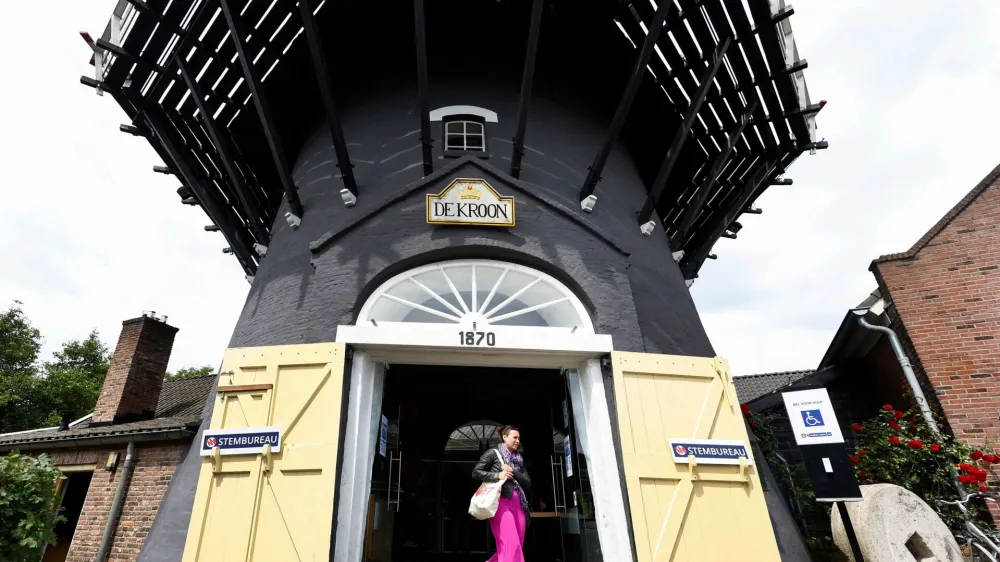 A woman walks out of a mill after voting in the European Union's parliamentary elections in Arnhem, Netherlands, June 6, 2024. REUTERS/Piroschka van de Wouw