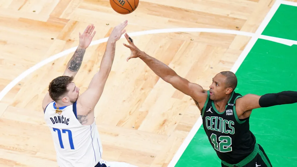 Jun 9, 2024; Boston, Massachusetts, USA; Dallas Mavericks guard Luka Doncic (77) shoots against Boston Celtics center Al Horford (42) in the first quarter during game two of the 2024 NBA Finals at TD Garden. Mandatory Credit: David Butler II-USA TODAY Sports