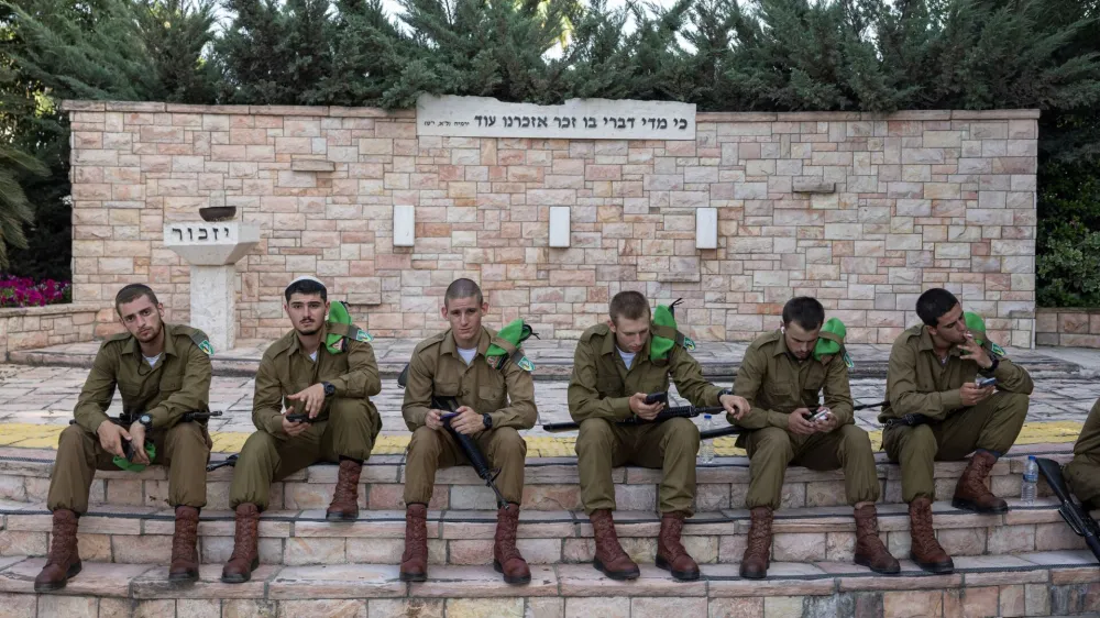 Soldiers take a rest after the funeral of Israeli soldier Staff sergeant Stanislav Kostarev, who was killed amid the ongoing conflict in Gaza between Israel and Hamas, in Ashdod, Israel, June 16, 2024. REUTERS/Marko Djurica