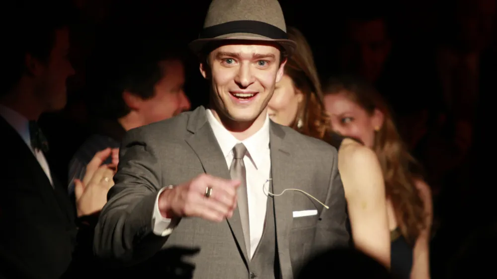 Actor, song writer and pop musician Justin Timberlake greets members of the audience before being presented with the Hasty Pudding Man of the Year on the school's campus, in Cambridge, Mass., Friday, Feb. 5, 2010. Timberlake, a Grammy and Emmy award winner, received the pudding pot from the nation's oldest undergraduate drama troupe during a roast Friday. (AP Photo/Steven Senne)