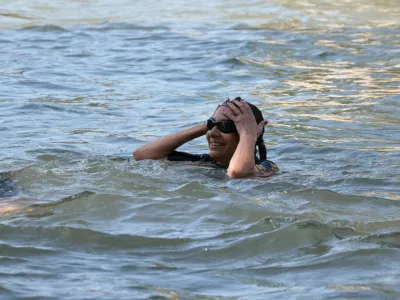 Paris Mayor Anne Hidalgo swims in the Seine, to demonstrate that the river is clean enough to host the outdoor swimming events at the Paris Olympics later this month, in Paris, France, July 17, 2024. JOEL SAGET/Pool via REUTERS
