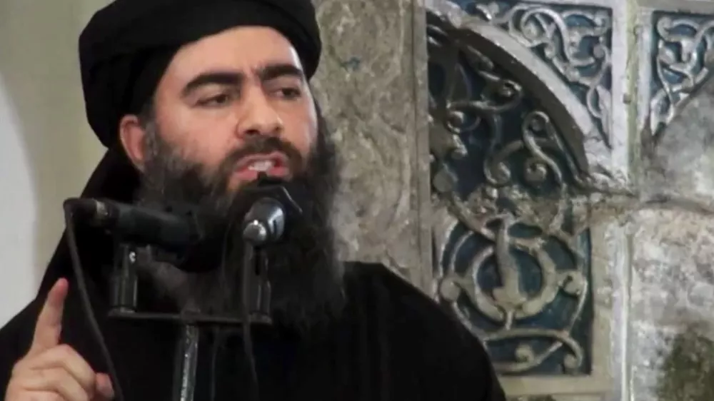 FILE - This file image made from video posted on a militant website Saturday, July 5, 2014, purports to show the leader of the Islamic State group, Abu Bakr al-Baghdadi, delivering a sermon at a mosque in Iraq during his first public appearance. The Islamic State group has released a new message purportedly from its reclusive leader, claiming his self-styled ?caliphate? is doing ?well? despite an unprecedented alliance against it. (AP Photo/Militant video, File)