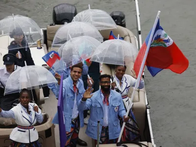 Paris 2024 Olympics - Opening Ceremony - Paris, France - July 26, 2024. Athletes of Haiti aboard a boat in the floating parade on the river Seine during the opening ceremony. REUTERS/Albert Gea