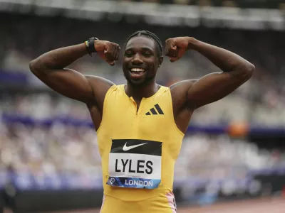 Winner Noah Lyles celebrates after the Men's 100m final during during the Diamond League London Athletics Meet in London, England, Saturday, July 20, 2024. (John Walton/PA via AP)