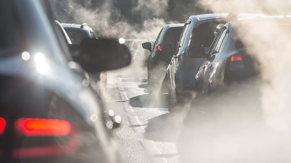 Moscow, Russia - August 08, 2017: Traffic jam. Blurred silhouettes of cars surrounded by steam from the exhaust pipes. Environmental pollution
