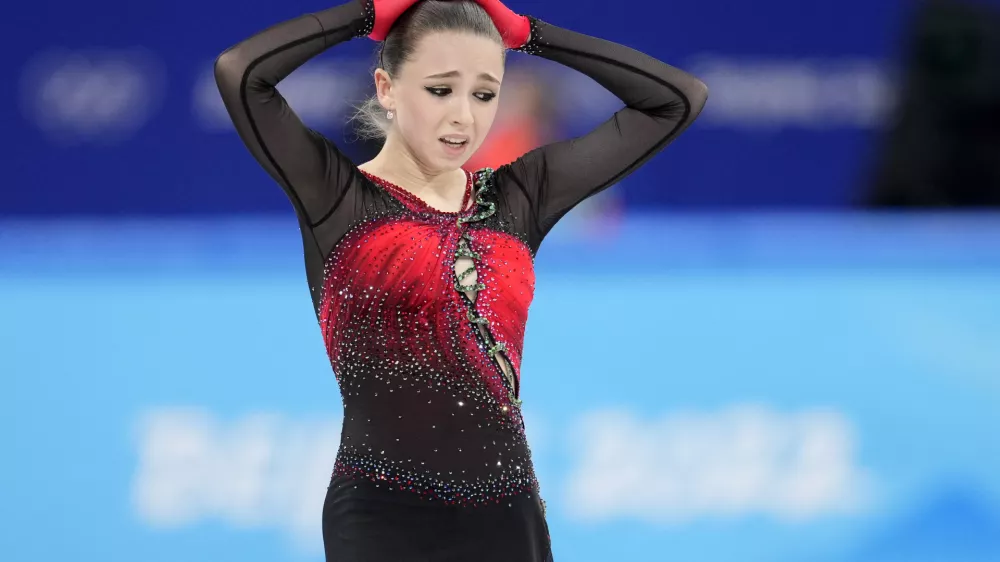 Kamila Valieva, 15, of the Russian Olympic Committee, reacts after the women's team free skate program during the figure skating competition at the 2022 Winter Olympics, Monday, Feb. 7, 2022, in Beijing. The 2022 Games' first major scandal has managed to involve the 15-year-old figure skater who has tested positive for using a banned heart medication that may cost her Russia-but-not-really-Russia team a gold medal in team competition. Kamila Valieva continues to train even as her final disposition is considered, and she may yet compete in the women's individual competition, in which she is favored. (AP Photo/Natacha Pisarenko)