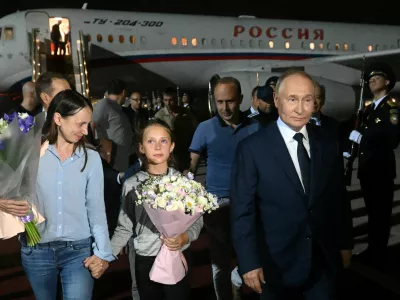 Russian President Vladimir Putin welcomes Russian nationals, including Artyom Dultsev, Anna Dultseva and their children, following a prisoner exchange between Russia with Western countries, during a ceremony at Vnukovo International Airport in Moscow, Russia August 1, 2024. Sputnik/Mikhail Voskresensky/Pool via REUTERS ATTENTION EDITORS - THIS IMAGE WAS PROVIDED BY A THIRD PARTY.