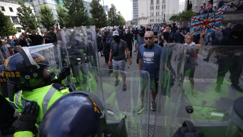 03 August 2024, United Kingdom, Liverpool: People protest in Liverpool, following the stabbing attacks on Monday in Southport, in which three young children were killed. Photo: James Speakman/PA Wire/dpa