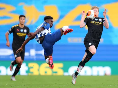 11 July 2020, England, Brighton: Brighton and Hove Albion's Yves Bissouma (L) challenges Manchester City's Kevin De Bruyne during the English Premier League soccer match between Brighton & Hove Albion and Manchester City at the Amex Stadium. Photo: Catherine Ivill/Nmc Pool/PA Wire/dpa