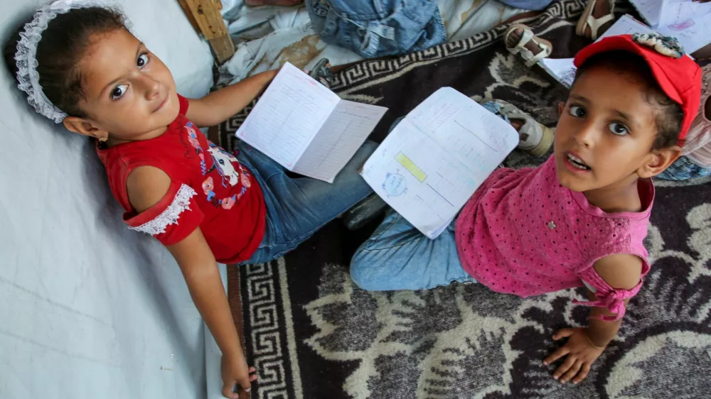 Palestinian students attend a class in a tent set up on the rubble of the house of teacher Israa Abu Mustafa, as war disrupts a new school year, amid the Israel-Hamas conflict, in Khan Younis, in the southern Gaza Strip, September 4, 2024. REUTERS/Hatem Khaled