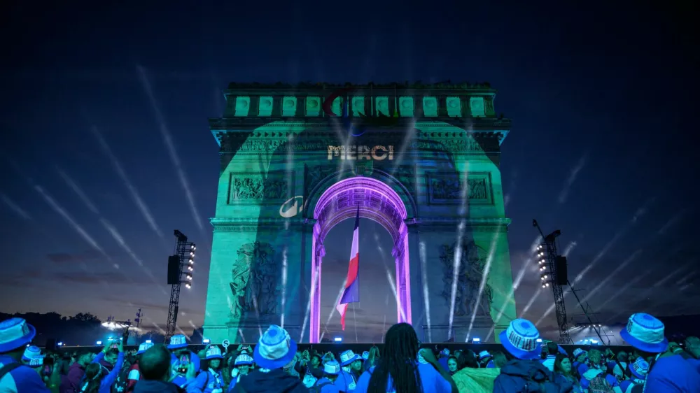 The word "Merci" (Thank you) is displayed on the Arc de Triomphe at the end of the parade of French athletes who competed in the Paris 2024 Olympic and Paralympic Games in Paris, France, September 14, 2024. ED JONES/Pool via REUTERS